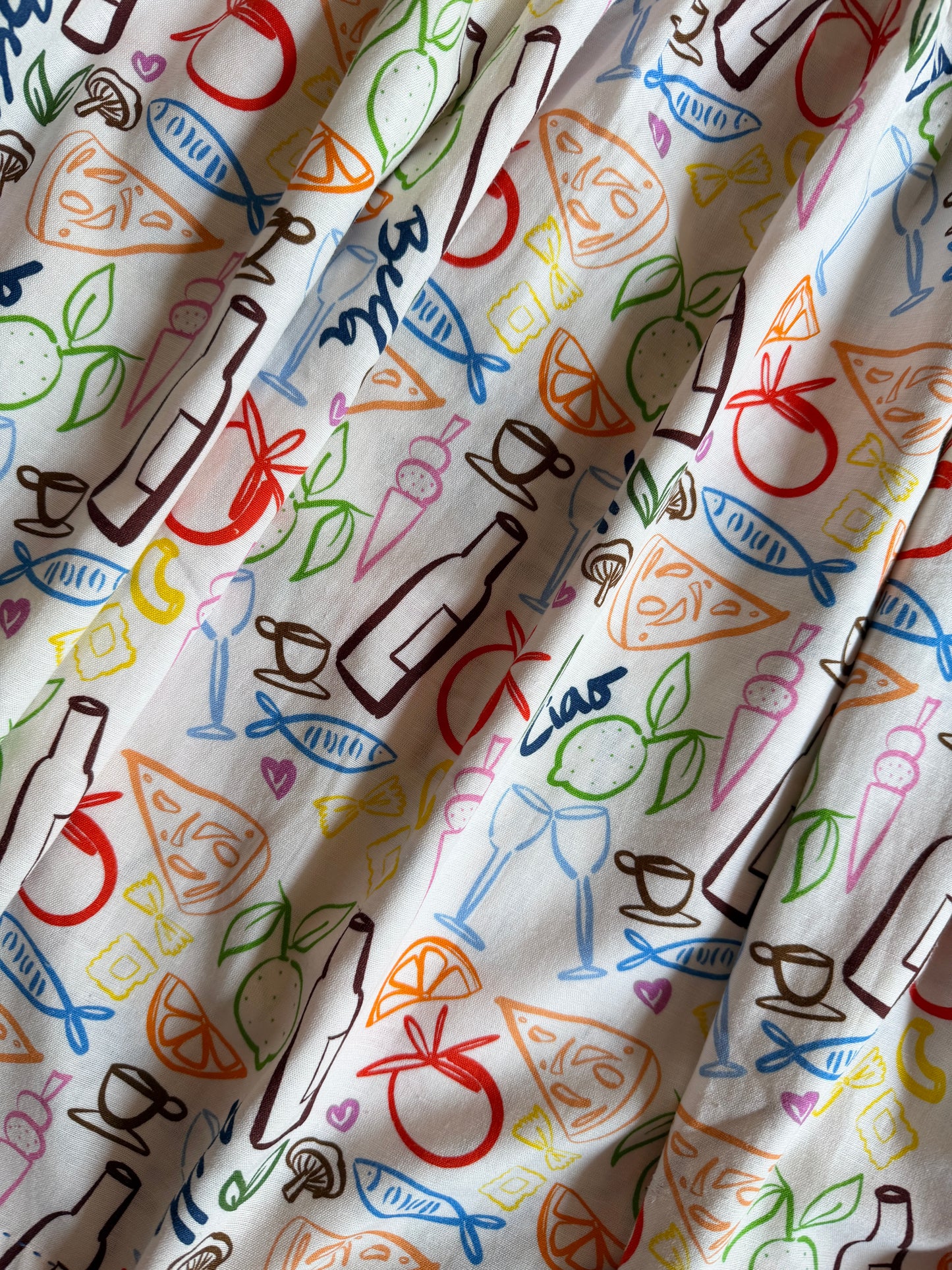 Close-up of custom Amalfi-inspired print with wine, lemons, pasta and seafood illustrations