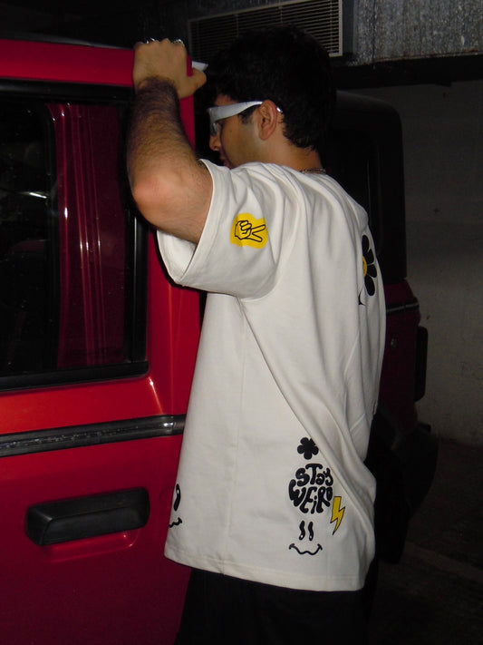 model wearing oversized ikami Sticker graphic T-shirt outdoors