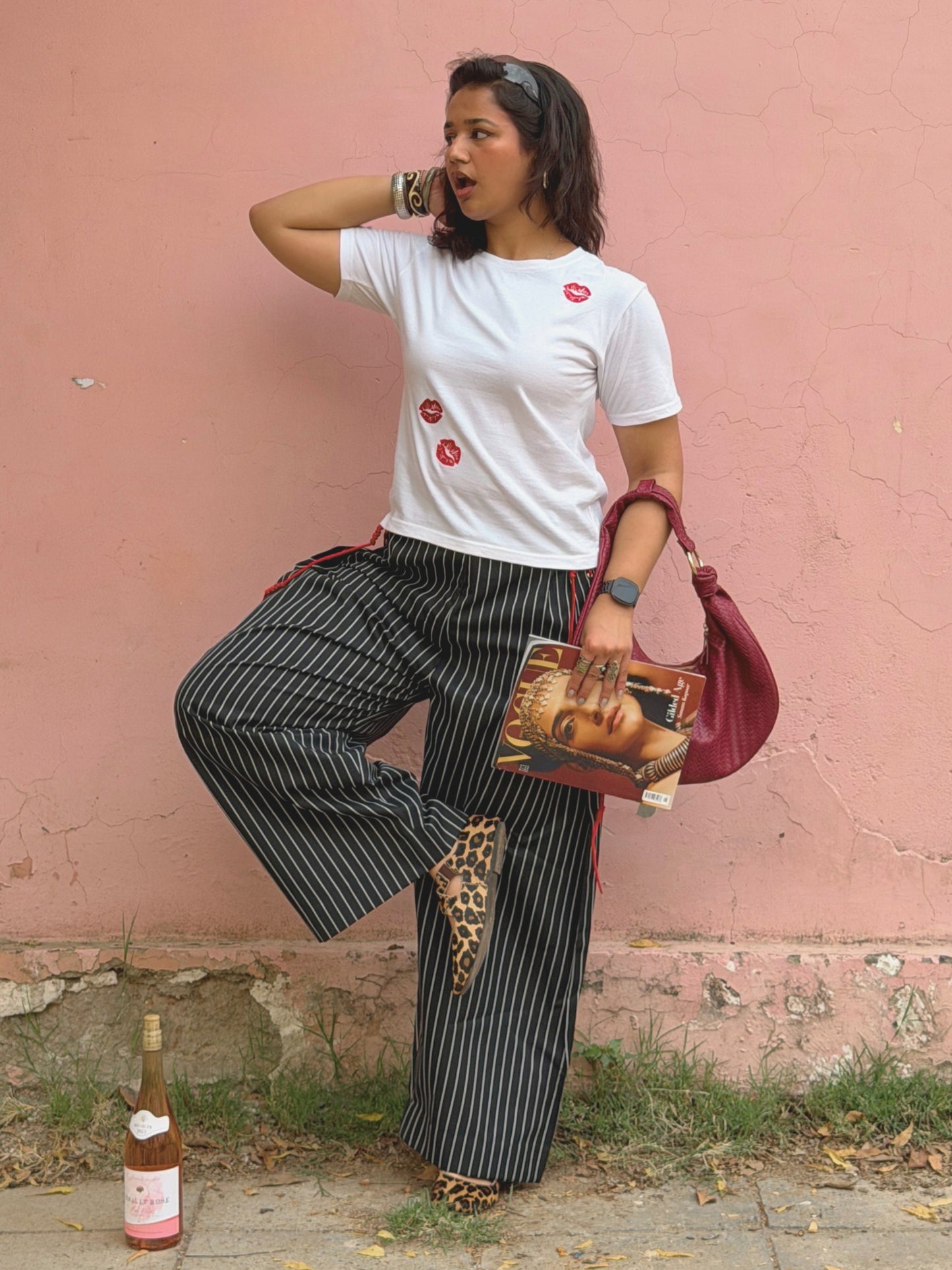 Model styling Ikami Paris embroidered top with statement ikami trousers holding vogue