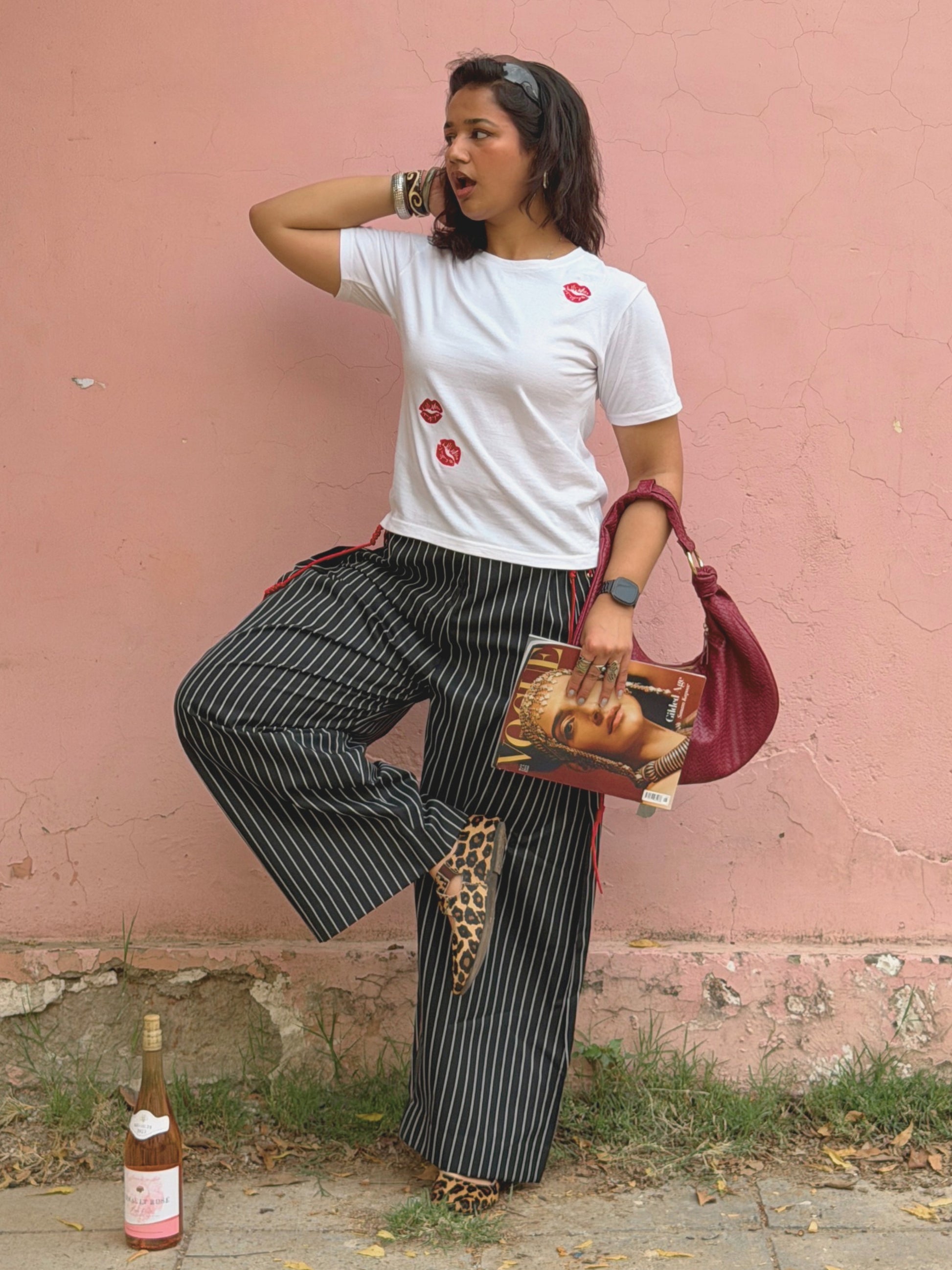 Model styling Ikami Paris embroidered top with statement ikami trousers holding vogue