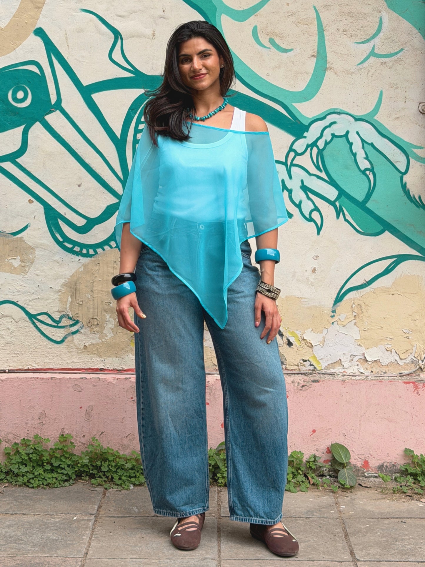 blue ikami Porto poncho styled as a vacation outfit
