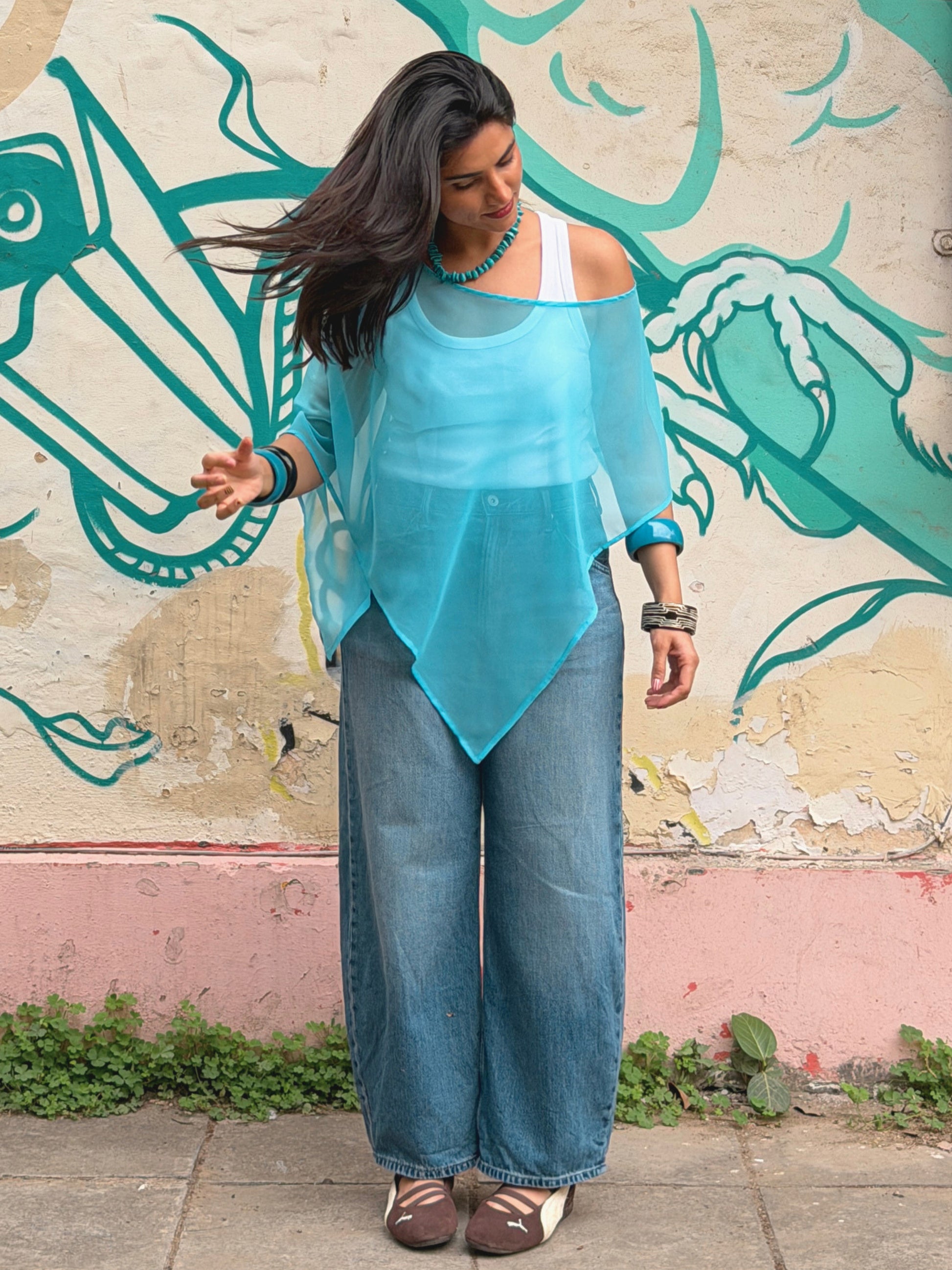 Blue sheer poncho styled as a resort wear layering piece