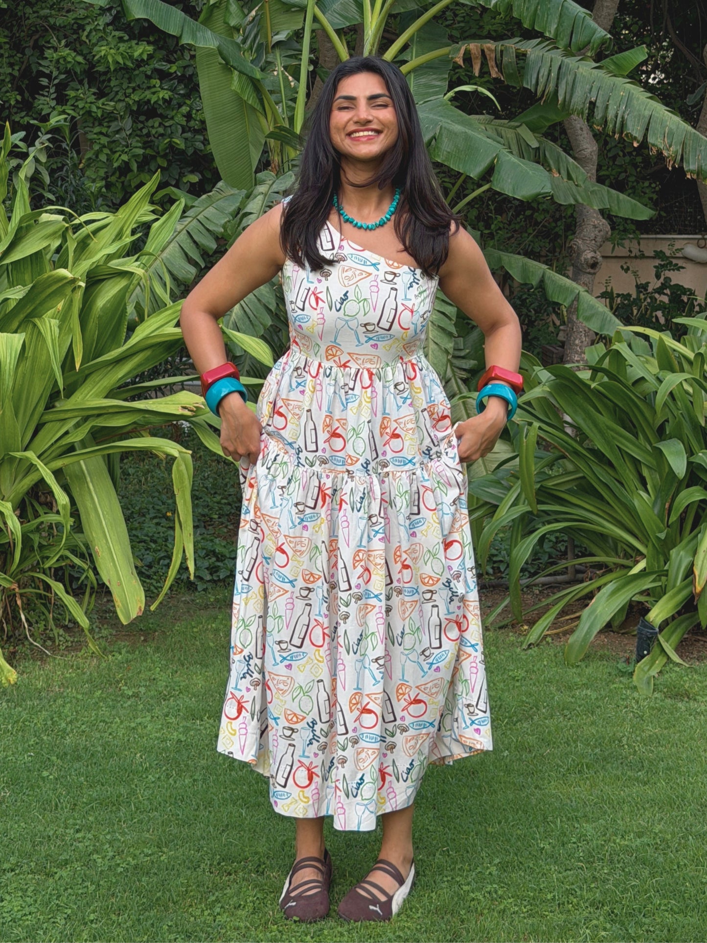 model in printed linen resort wear dress styled for a euro summer outfit standing outdoors
