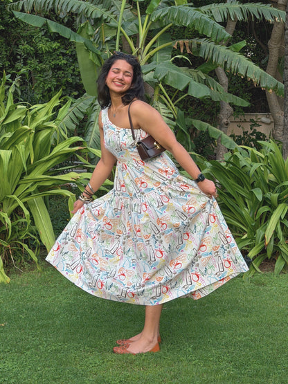 model in ikami amalfi dress posing outdoors with greenery in the background