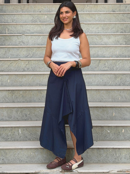 model wearing navy blue ikami berlin statement skirt on outdoor steps