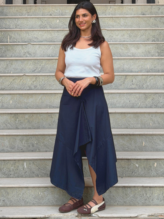 model wearing navy blue ikami berlin statement skirt on outdoor steps