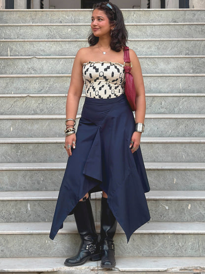 model wearing navy blue ikami berlin statement skirt with a cool top and boots
