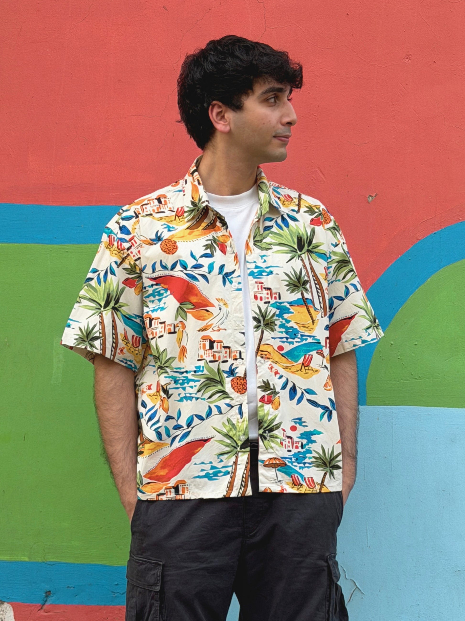 model wearing the colourful ikami mykonos shirt with a white t-shirt underneath