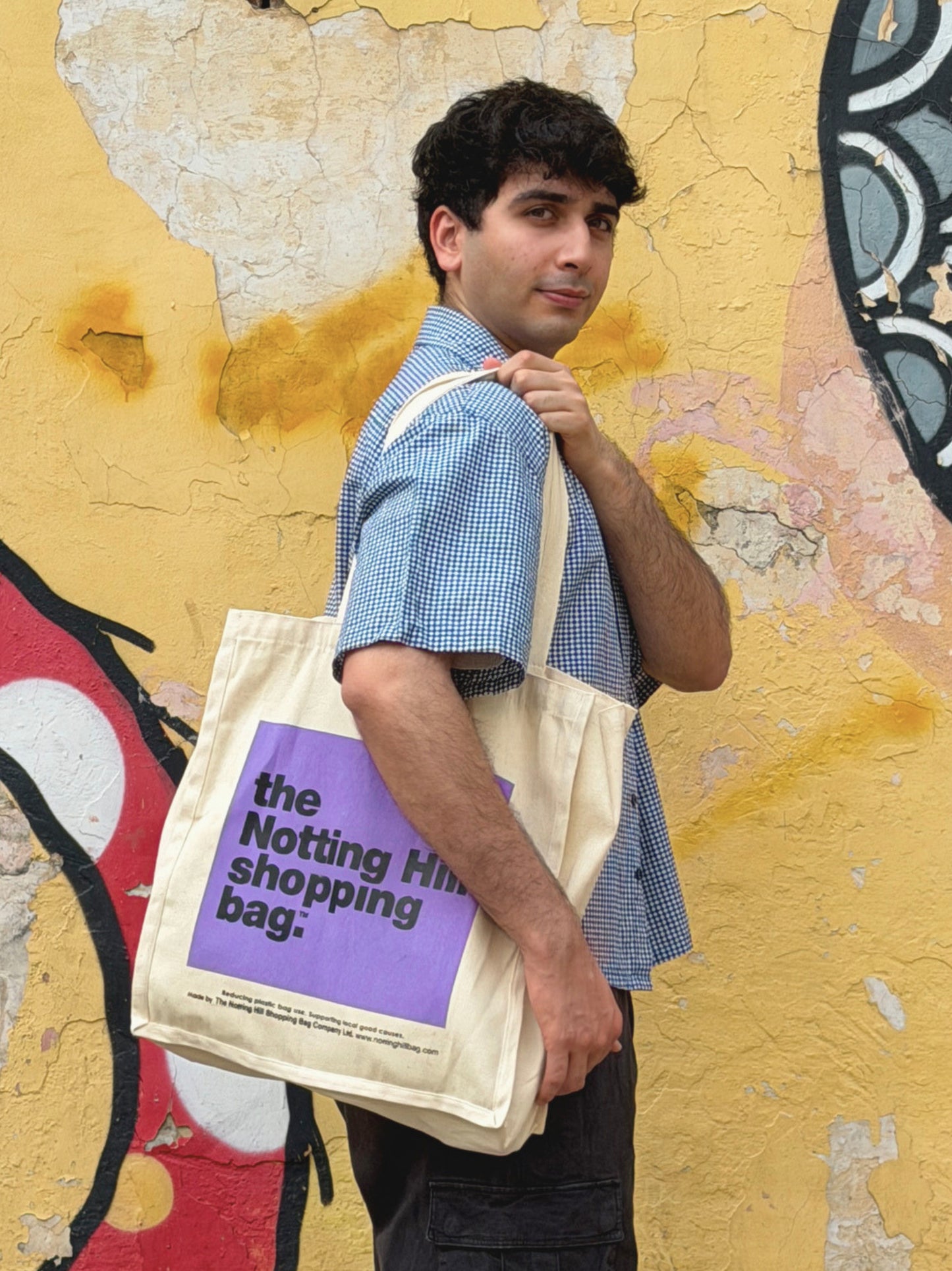 model wearing the classic ikami london shirt with the notting hill tote bag from london