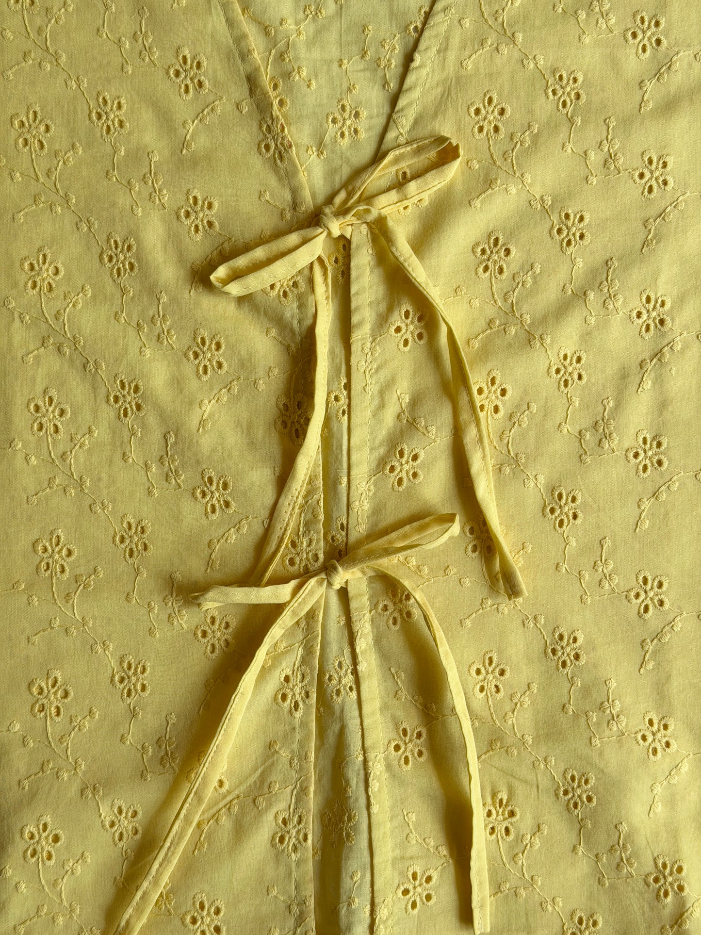 close up of the yellow ikami copenhagen top with front tie deails 