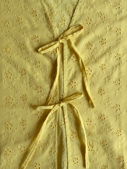 close up of the yellow ikami copenhagen top with front tie deails 