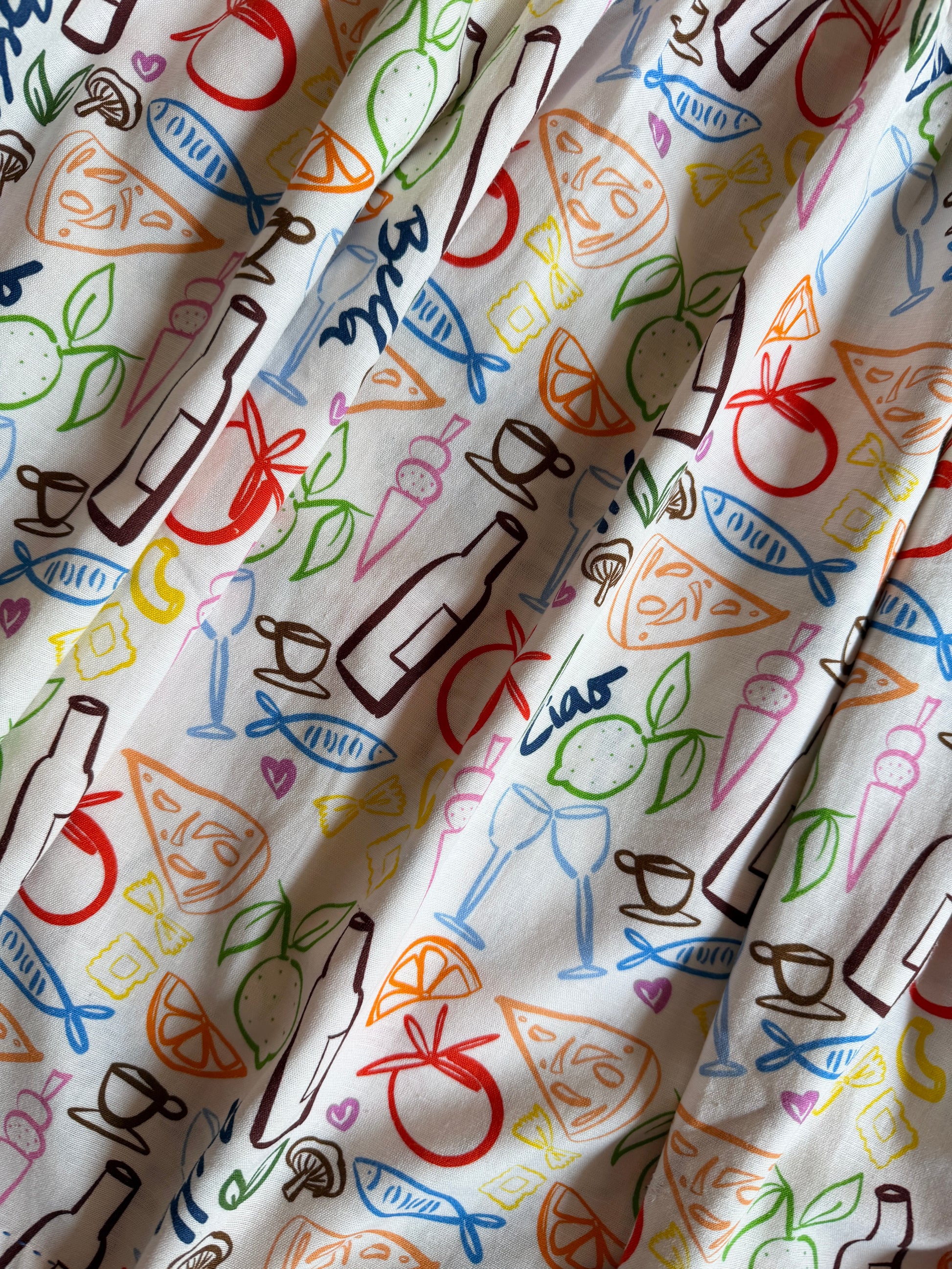 Close-up of custom Amalfi-inspired print with wine, lemons, pasta and seafood illustrations